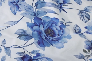 Detailed macro view of the blue floral print on high-quality white cotton fabric