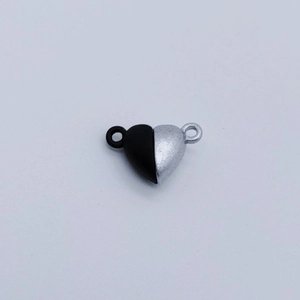 Detail view of heart-shaped magnetic clasp in black and silver for jewelry making