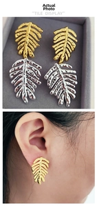 Detail of Monstera leaf brass earrings with hammered texture and realistic ear-worn view