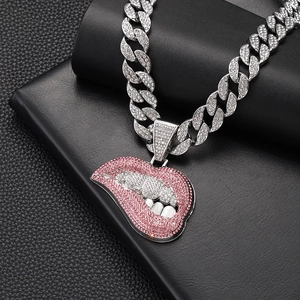 Detailed view of silver Cuban link chain with a sparkling pink diamond-set lip pendant