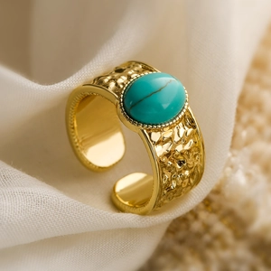 18K gold-plated wide geometric open ring with oval turquoise on beige fabric
