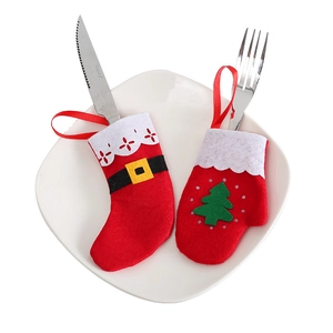 Felt Christmas stocking and glove cutlery holders with tree decor on a white plate