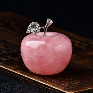 Detailed view of pink quartz apple decor with silver stem and sparkling rhinestones