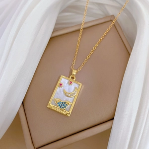 Golden Tarot Moon necklace with stars and wolf on pearl background with a gold chain