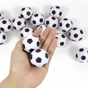 Miniature black and white foam soccer balls held in a hand showing the small 4cm scale