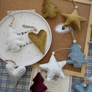Detailed plush holiday ornaments with gold wire, wooden beads, and silver sequins on cork