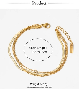 Detailed view of triple-layered golden stainless steel chain bracelet with zircon charm