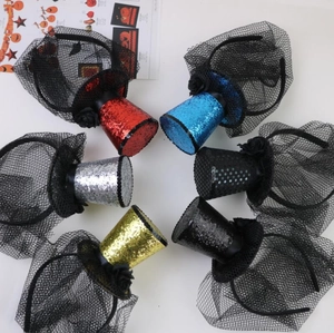 Top view of six sequined mini top hats with black veils on headbands for party costumes