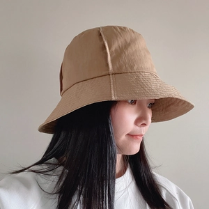 Waterproof nylon bucket hat in khaki finish shown on a model from a side profile view