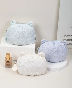 Detailed close-up of lace cat-ear cosmetic bags with floral embroidery and cute design