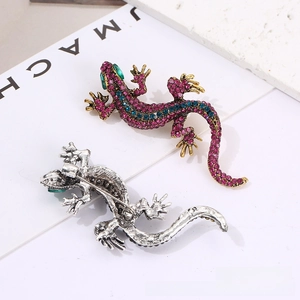 Macro detail showing vintage gecko brooch front with colorful rhinestones and metal back pin