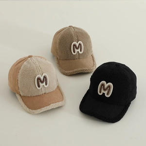 Detailed view of lamb wool baseball caps with embroidered M patch in three colors