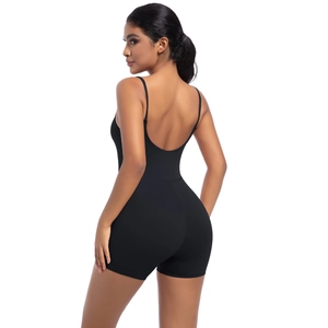 Detail of black cross-back straps and open back design on a fitness bodysuit