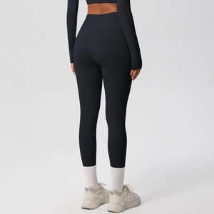 Macro detail of high-waisted black leggings with contouring and butt-lifting stitching