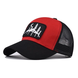 Close-up of red and black trucker hat featuring forest and moon embroidery patch