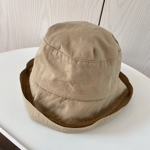 Top down shot of a khaki cotton bucket hat with circular reinforced stitching details