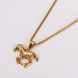 Detailed view of a vintage gold horse pendant with embossed patterns and chain
