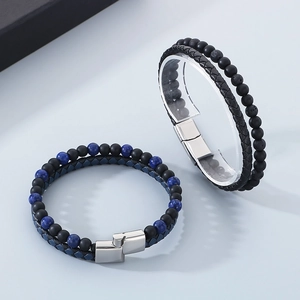 Detail of hand-woven leather bracelets with tiger eye beads and magnetic clasp