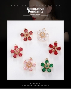 Macro shot of gold-plated copper flower pendants with colorful cubic zirconia stones