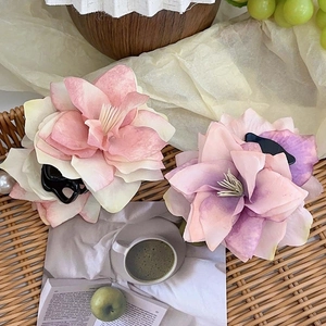 3D faux flower hair claws in pink and purple gradient set in a woven tray