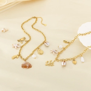 Detail of 18K gold plated ocean theme necklace with starfish and seashell charms