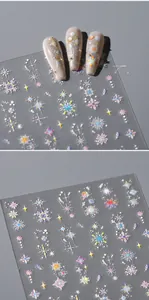 Macro shot of holographic snowflake and star nail stickers with iridescent laser effect