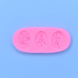 Pink silicone Christmas mold with bell, tree, and angel shapes for DIY baking and crafts