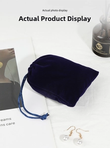 Close-up of a premium dark blue velvet jewelry pouch with elegant silk drawstring
