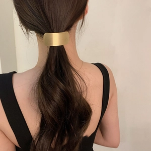 Minimalist rectangular gold matte metal hair ring for women shown on a ponytail