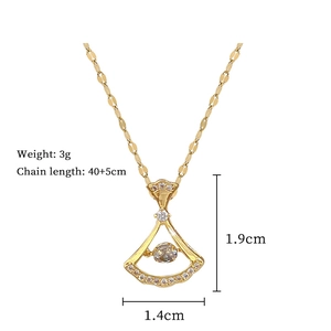 Detail view of a gold skirt-shaped pendant with diamonds and size 1.4x1.9cm