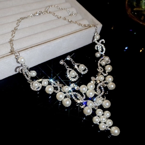 Close-up of teardrop pearl and rhinestone necklace set on a luxury jewelry box