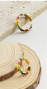Detailed close-up of colorful enamel evil eye rings in 18k gold plated stainless steel