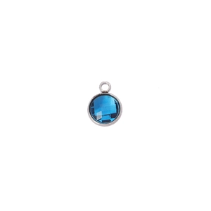 Detailed close-up of a 7mm round faceted blue birthstone charm with silver metal bezel
