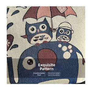 Detailed close-up of ethnic canvas bag showing woven owl and elephant patterns