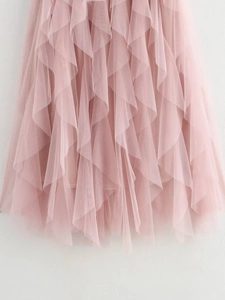 Close-up of pink layered mesh tulle fabric and ruffled hem details of the skirt