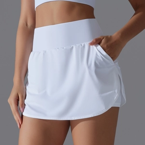 Detail of high-waisted white tennis skort showing side pocket and sleek athletic fabric