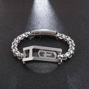 Detailed view of silver square link chain bracelet with a hollow cross center piece