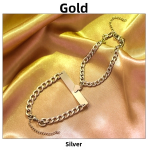 Detailed shot of gold and silver heart bracelets with tags on elegant silk fabric