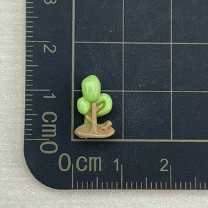 Detailed view of mini resin tree charm on a measuring mat showing 1.5cm small scale