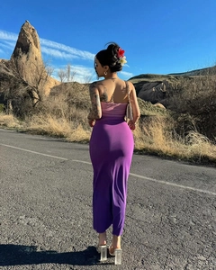 Rear view of a slim-fit pink tube top and purple high-waisted skirt set on a road