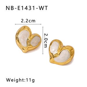 Detail view of gold heart earrings with white enamel showing 2.2cm width and 2.0cm height
