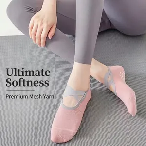 Pink cotton yoga socks with grey cross straps and anti-slip silicone dots for pilates