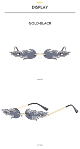 Close-up of rimless flame shaped sunglasses with rhinestone edges and gold-black finish