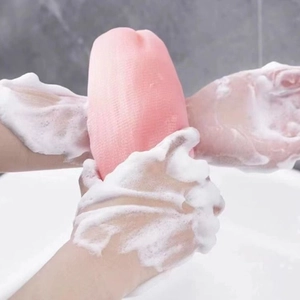 Pink exfoliating foaming net creating thick lather for shower and body washing
