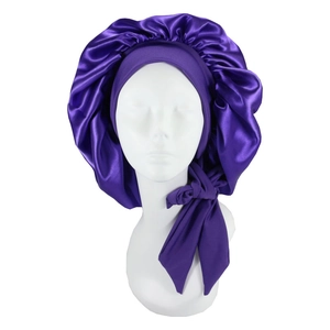 Close-up of purple satin sleep bonnet with adjustable wide straps on a model head
