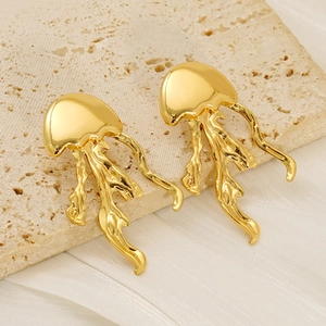 Detailed macro view of jellyfish-shaped titanium steel earrings with polished gold finish