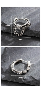 Detail view of vintage punk earrings with cross motifs and belt buckle chain design