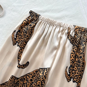 Luxurious satin lounge pants featuring elegant leopard print and elastic waistband