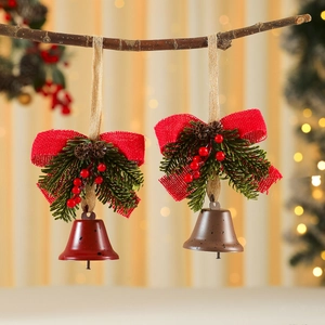 Christmas iron bells with red bow, pine cones and berries hanging on a wooden branch