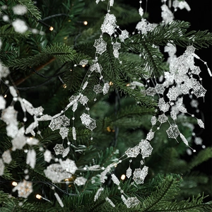 Christmas tree garland with ice crystal snowflake beads and warm fairy lights decor